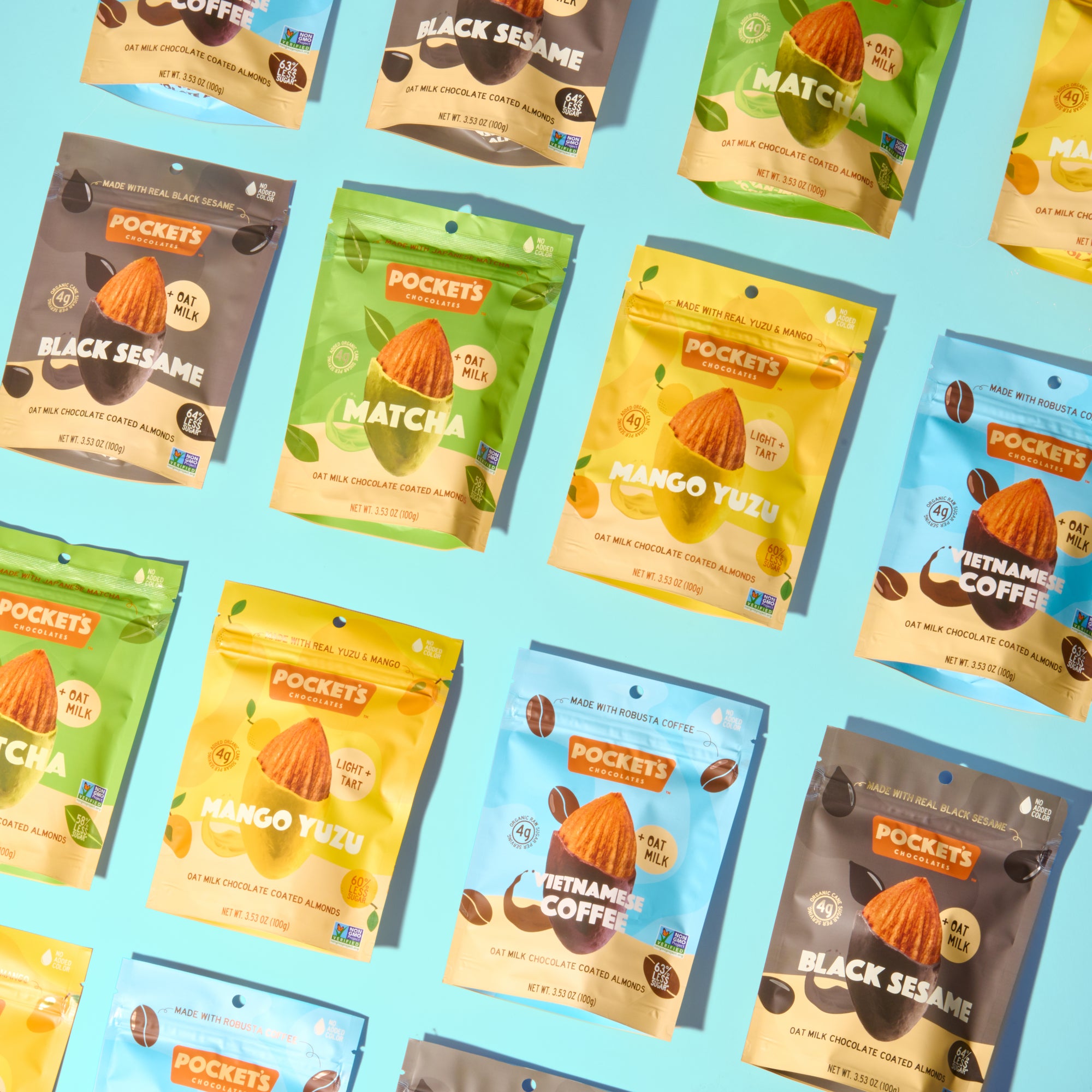 An arrangement of various flavored almond snack packs on a light blue background