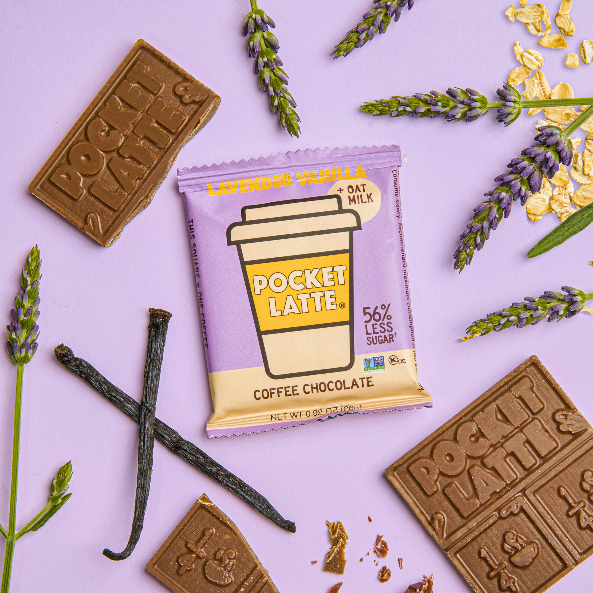 A Pocket Latte coffee chocolate bar in lavender vanilla flavor, surrounded by chocolate pieces, lavender, and vanilla beans