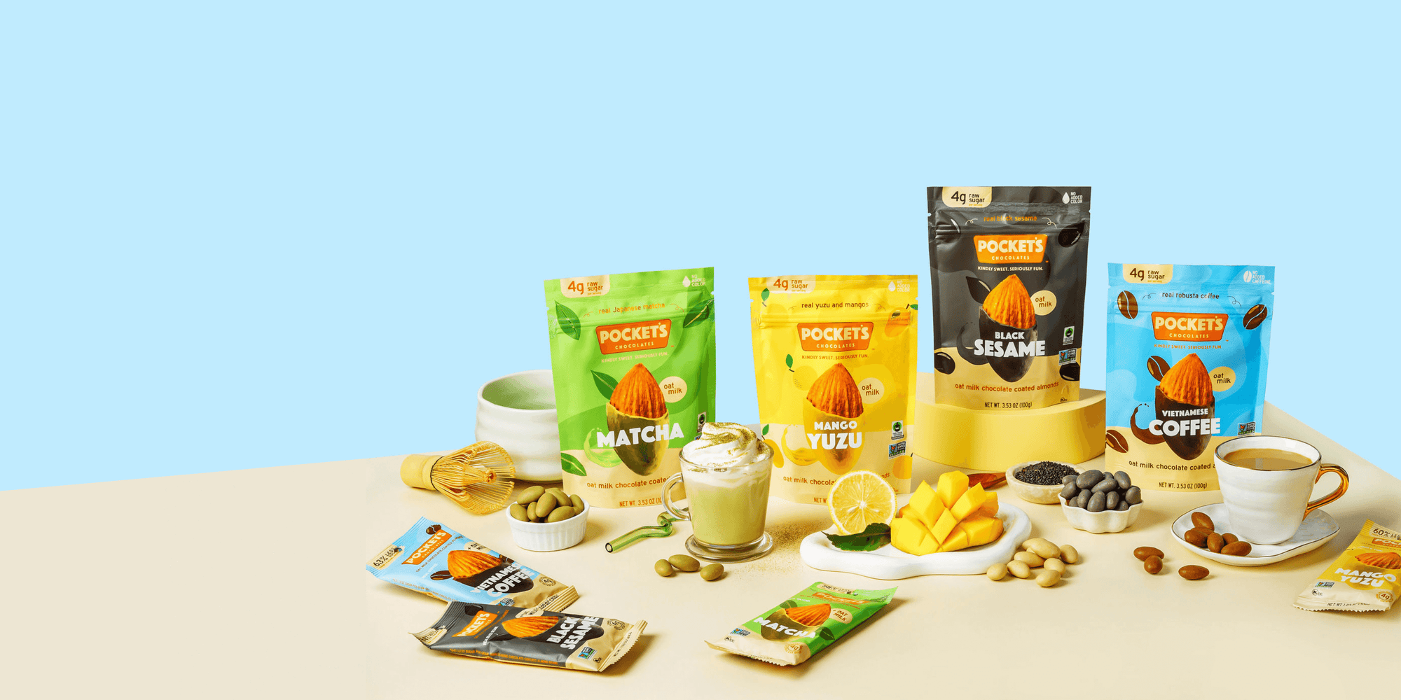 Arrange Pocket's chocolate packages with matcha, mango yuzu, black sesame, and Vietnamese coffee alongside beverages.