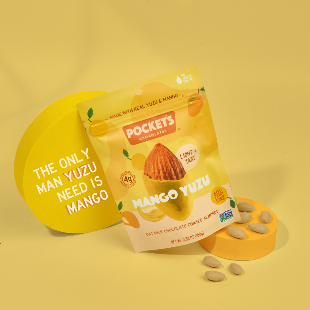 Pocket's Chocolates' Mango Yuzu chocolate almonds with text that reads "The only man yuzu need is mango".